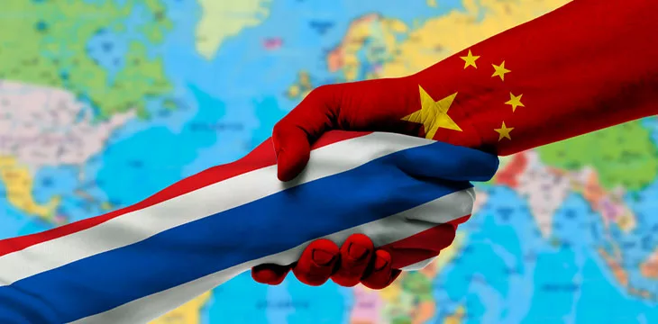 Handshake between Thailand and China flags