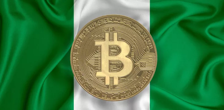 Nigeria flag draped over a bitcoin digital asset